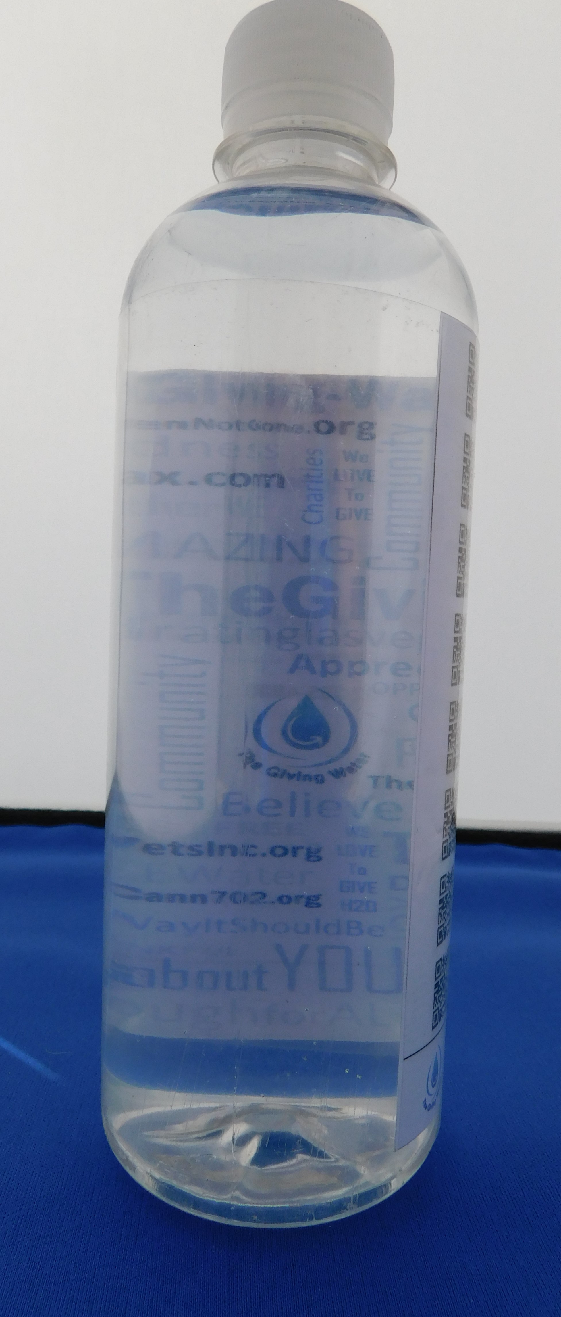 A Giving Water bottle showing a sponsor logo on the co-brand panel